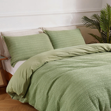 Load image into Gallery viewer, Sage green waffle-textured duvet cover set styled with matching shams