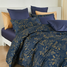 Load image into Gallery viewer, Navy blue duvet cover set with gold floral pattern on white bed frame
